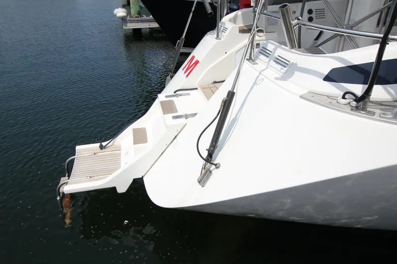 Slide: The Image of Nautor Swan 48 yacht stern with swim platform, 1997 model, docked in calm water. - 5