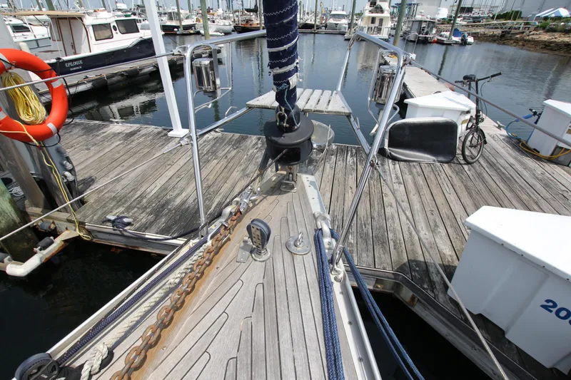 Slide: The Image of Bow of 1997 Nautor Swan 48 yacht docked at marina with wooden pier. - 6