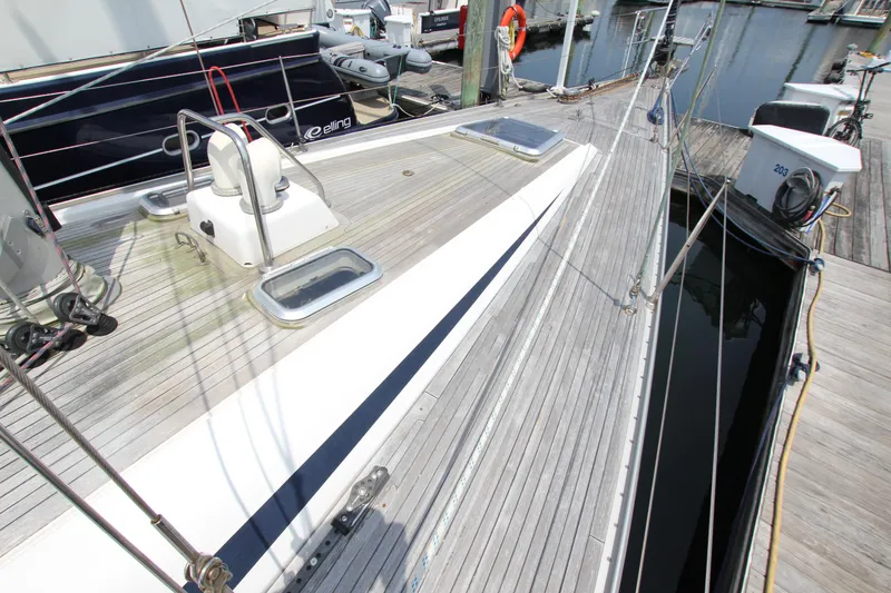 Slide: The Image of Deck view of 1997 Nautor Swan 48 yacht at marina, showcasing sleek design and craftsmanship. - 9