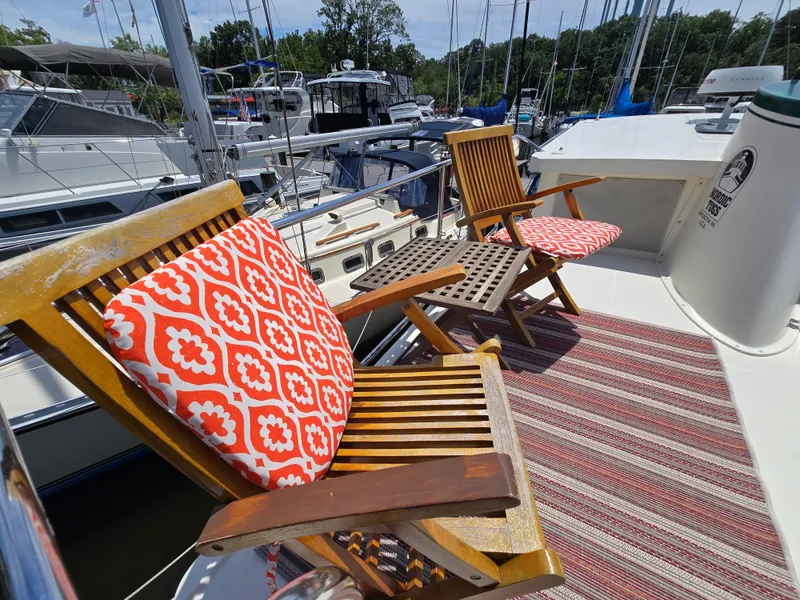 Slide: The Image of Deck of 2001 Nordic Tug 32 with wooden chairs and patterned cushions. - 17