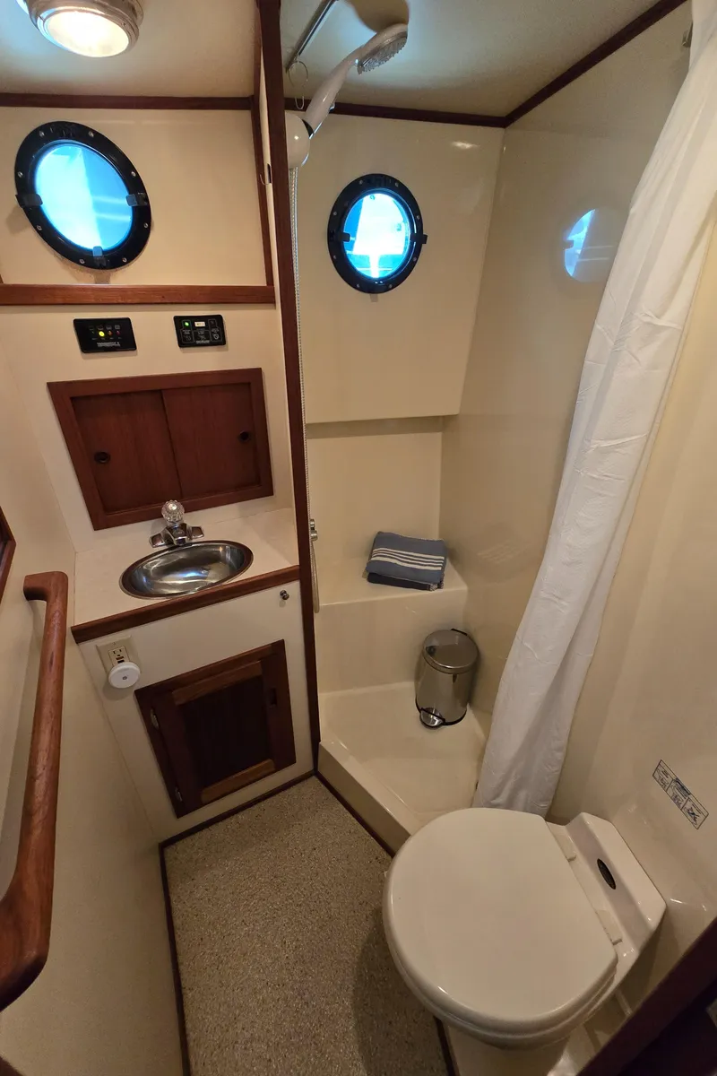 Slide: The Image of Bathroom interior of 2001 Nordic Tug 32 with sink, toilet, and shower. - 22