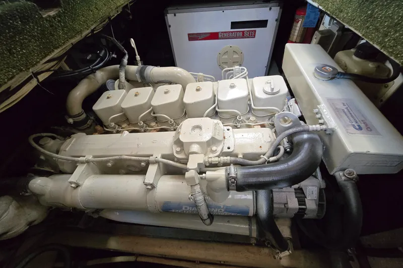 Slide: The Image of Engine compartment of a 2001 Nordic Tug 32, featuring a diesel engine and generator. - 24