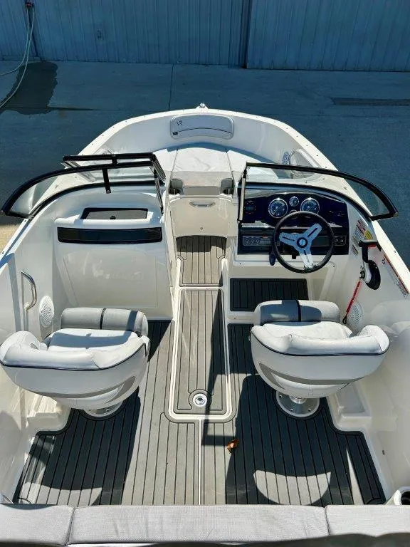 Slide: The Image of 2022 Bayliner VR4 Bowrider I/O interior with dual captain seats and modern dashboard. - 11