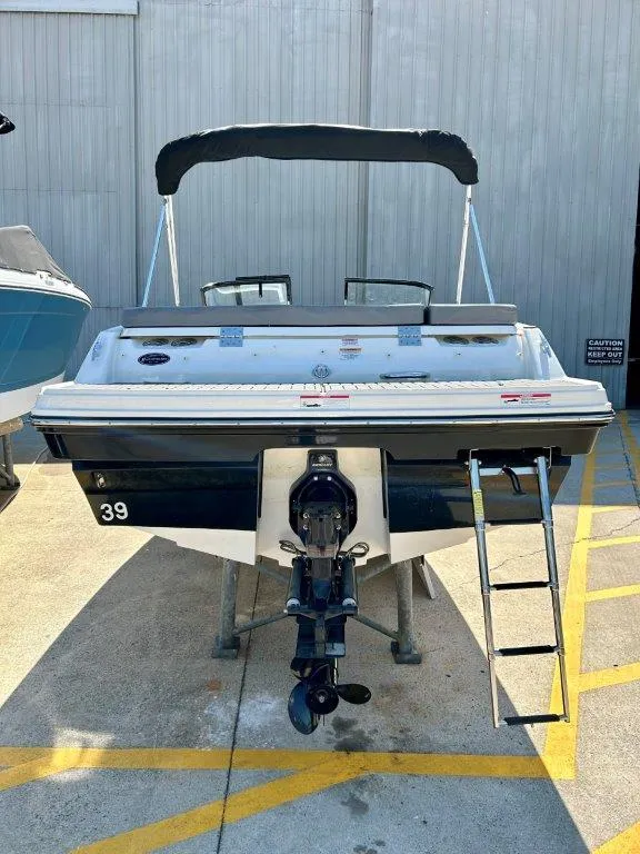 Slide: The Image of 2022 Bayliner VR4 Bowrider I/O boat with ladder and canopy, rear view. - 13