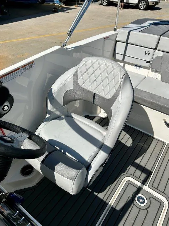 Slide: The Image of 2022 Bayliner VR4 Bowrider I/O interior with captain's chair and steering wheel. - 4