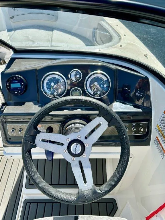 Slide: The Image of 2022 Bayliner VR4 Bowrider I/O dashboard and steering wheel. - 5