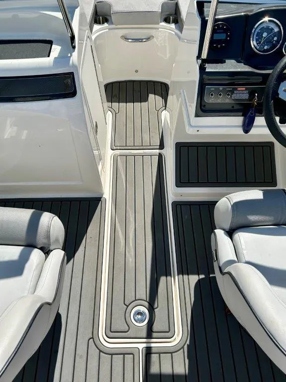 Slide: The Image of 2022 Bayliner VR4 Bowrider I/O interior cockpit with gray flooring and white seating. - 9