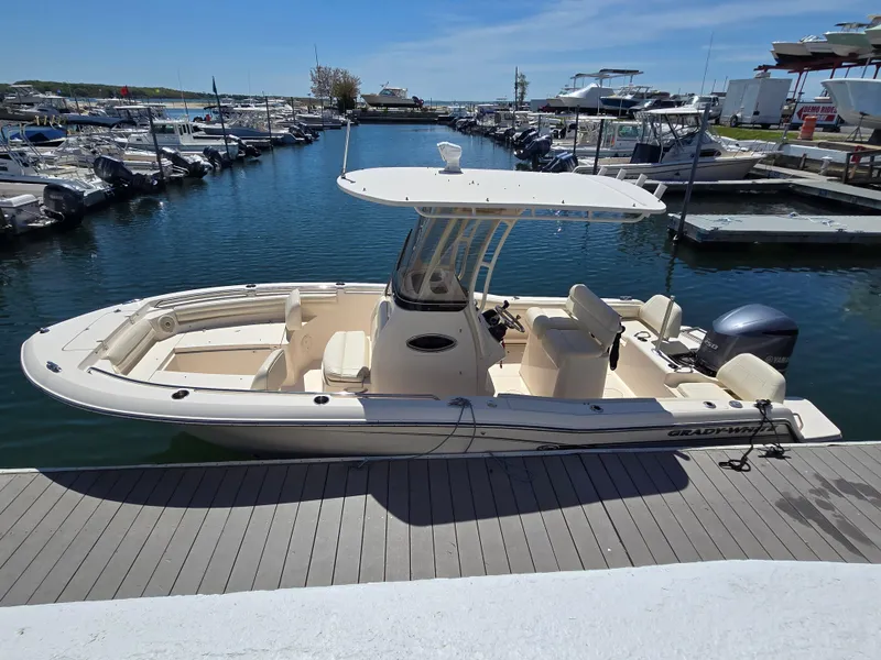 Slide: The Image of 2019 Grady-White Fisherman 216 boat docked at a marina under clear skies. - 1