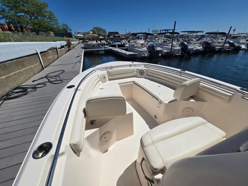 Slide: The Image of 2019 Grady-White Fisherman 216 boat docked at marina, featuring spacious seating area. - 11