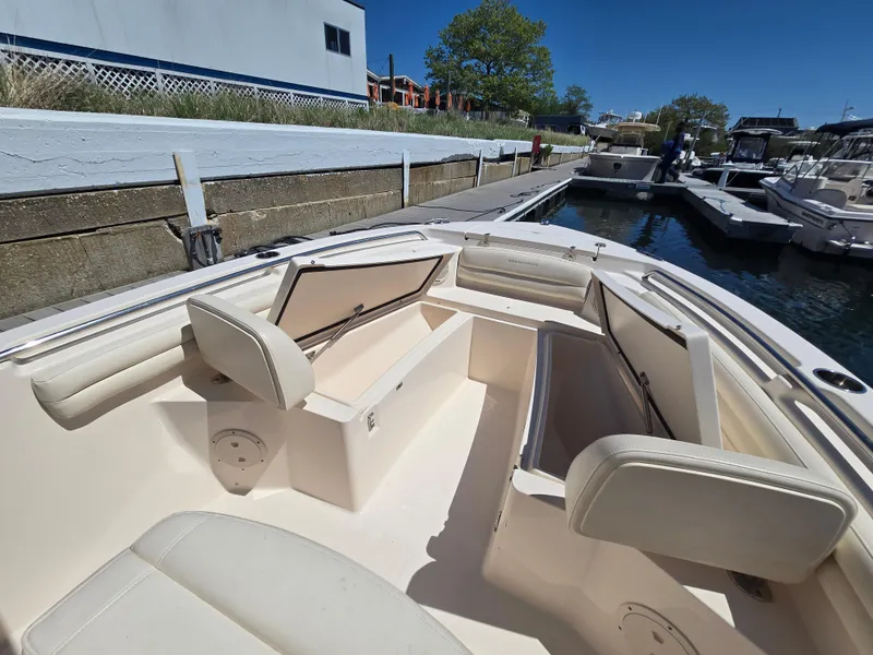 Slide: The Image of 2019 Grady-White Fisherman 216 boat interior with open storage compartments at dock. - 12