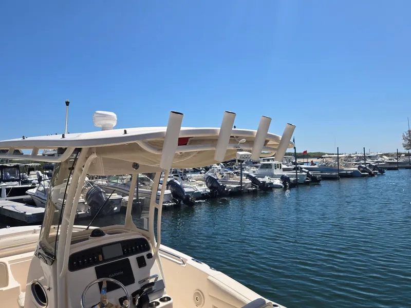 Slide: The Image of 2019 Grady-White Fisherman 216 boat docked at a marina under clear blue skies. - 13