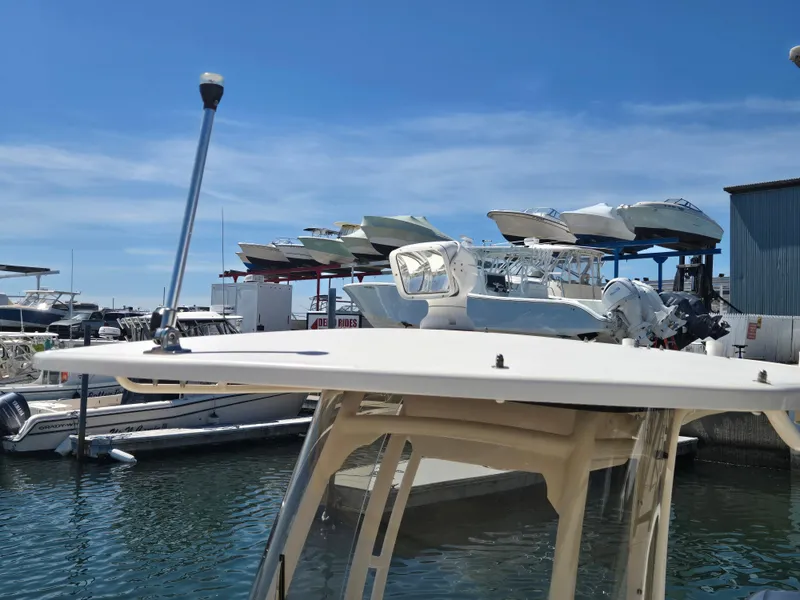 Slide: The Image of 2019 Grady-White Fisherman 216 boat docked at a marina with stacked boats. - 14