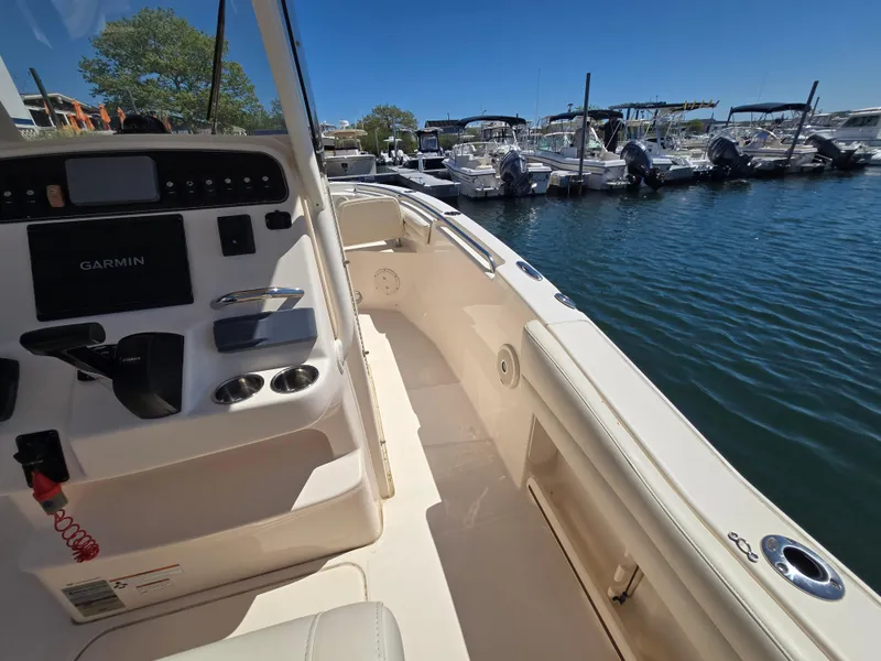 Slide: The Image of 2019 Grady-White Fisherman 216 boat interior with Garmin system, docked at marina. - 6