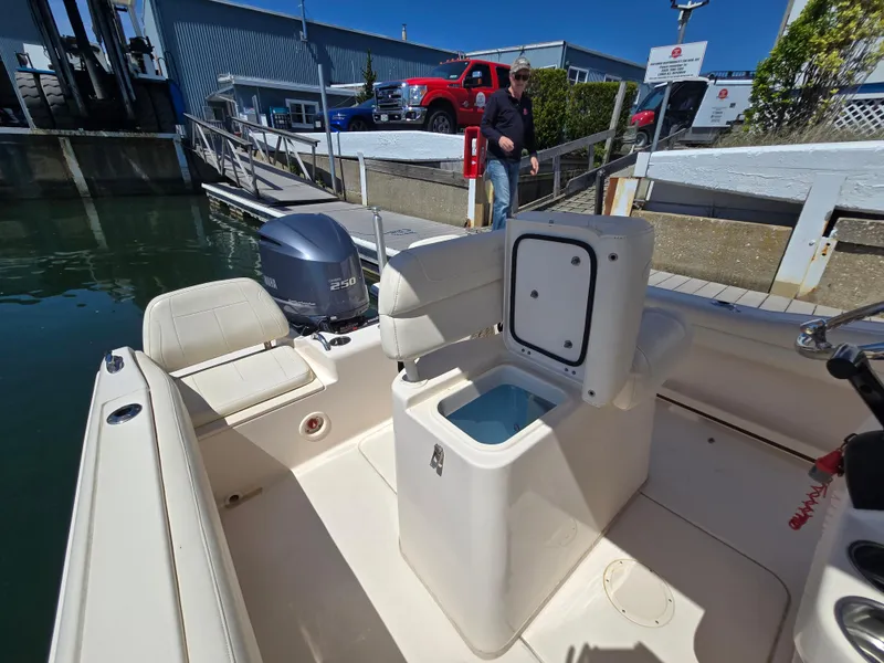 Slide: The Image of 2019 Grady-White Fisherman 216 boat interior with open storage compartment at dock. - 8