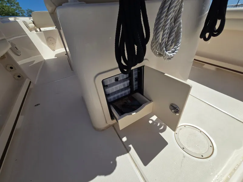 Slide: The Image of 2019 Grady-White Fisherman 216 boat storage compartment with ropes and tackle box. - 9