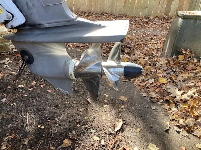 Slide: The Image of 1986 Albemarle 24 Cuddy boat propeller in a yard with fallen leaves. - 11