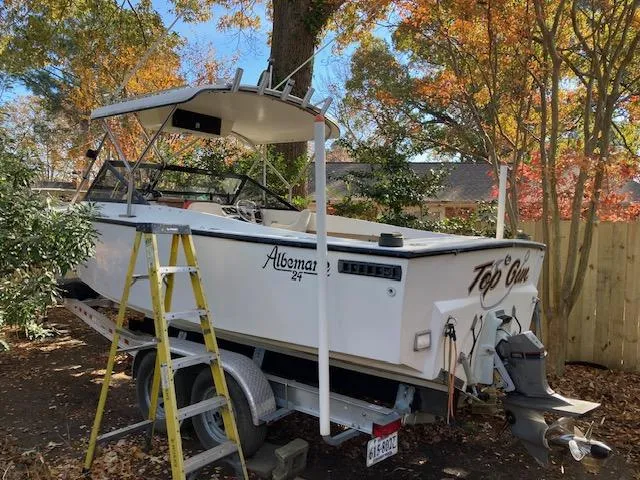 Slide: The Image of 1986 Albemarle 24 Cuddy boat on trailer, surrounded by autumn trees. - 12