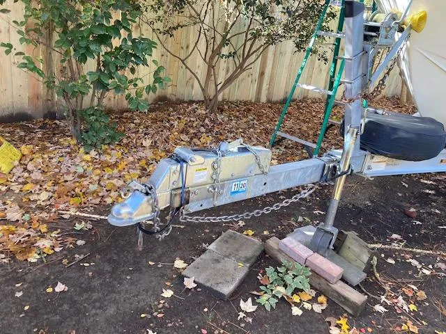 Slide: The Image of Trailer hitch of 1986 Albemarle 24 Cuddy boat, surrounded by autumn leaves. - 2