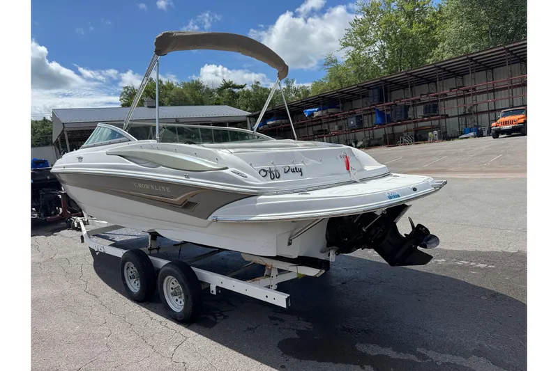 Slide: The Image of 2008 Crownline 220 LS boat on trailer, parked outdoors under a clear sky. - 10