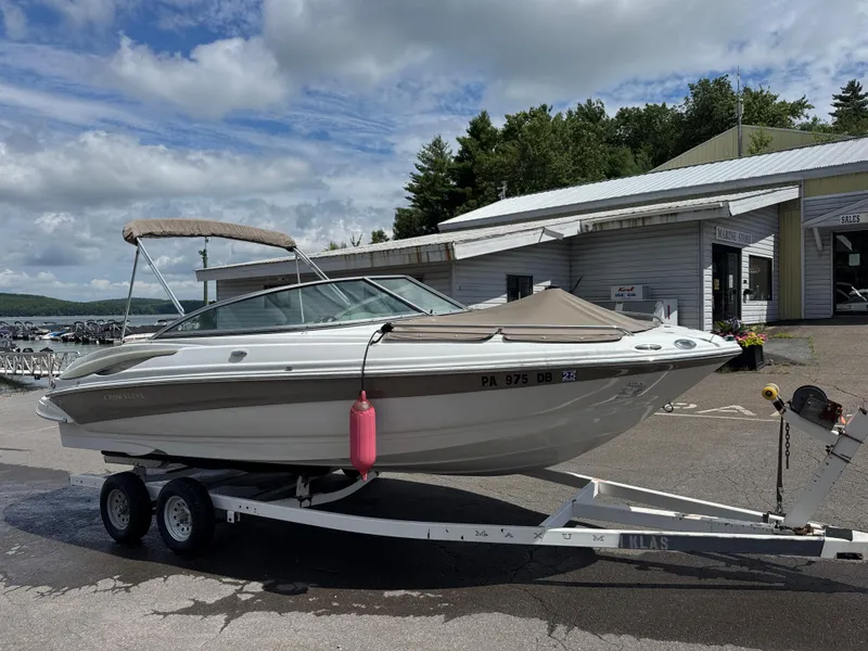 Slide: The Image of 2008 Crownline 220 LS boat on trailer at marina, under cloudy sky. - 3