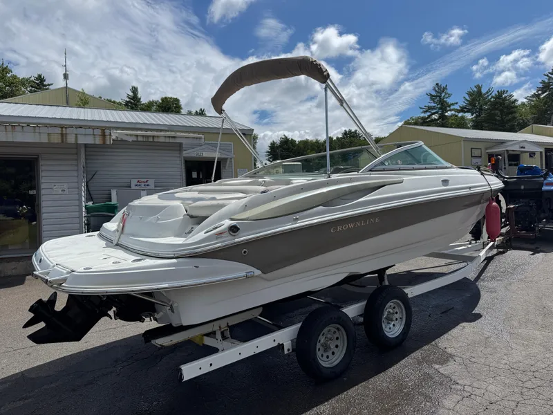 Slide: The Image of 2008 Crownline 220 LS boat on trailer, parked outdoors under a partly cloudy sky. - 5