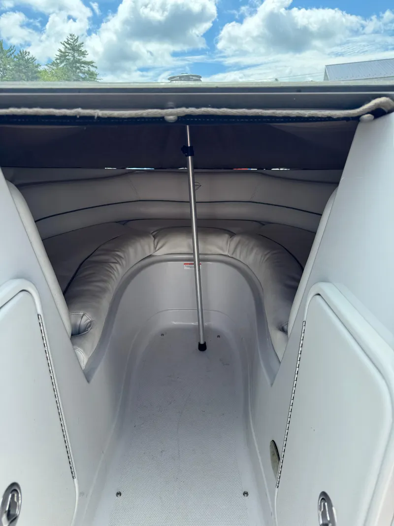 Slide: The Image of 2008 Crownline 220 LS boat interior with cushioned seating and storage compartments. - 7