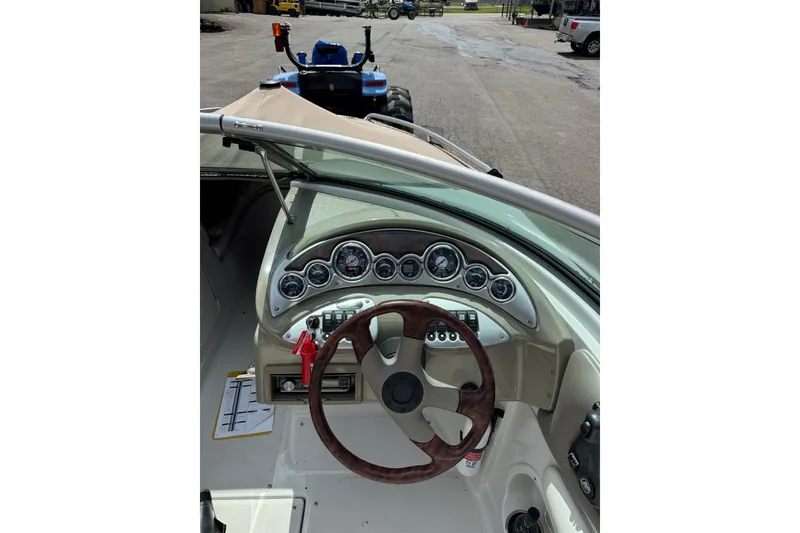 Slide: The Image of 2008 Crownline 220 LS boat dashboard with steering wheel and gauges. - 9