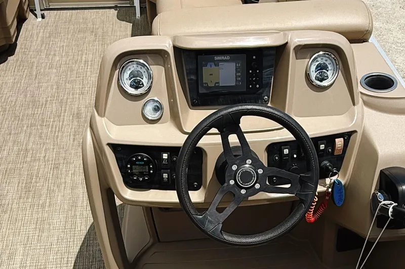 Slide: The Image of 2022 Starcraft LX22 boat dashboard with steering wheel and navigation system. - 14