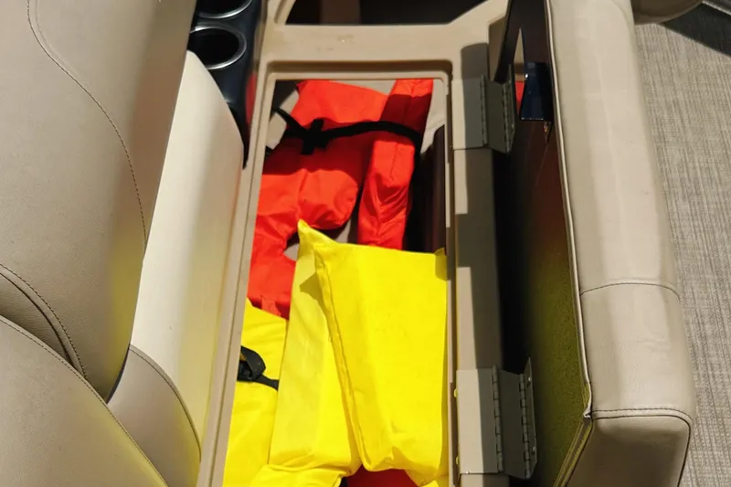 Slide: The Image of Storage compartment in 2022 Starcraft LX22 boat with life jackets. - 15