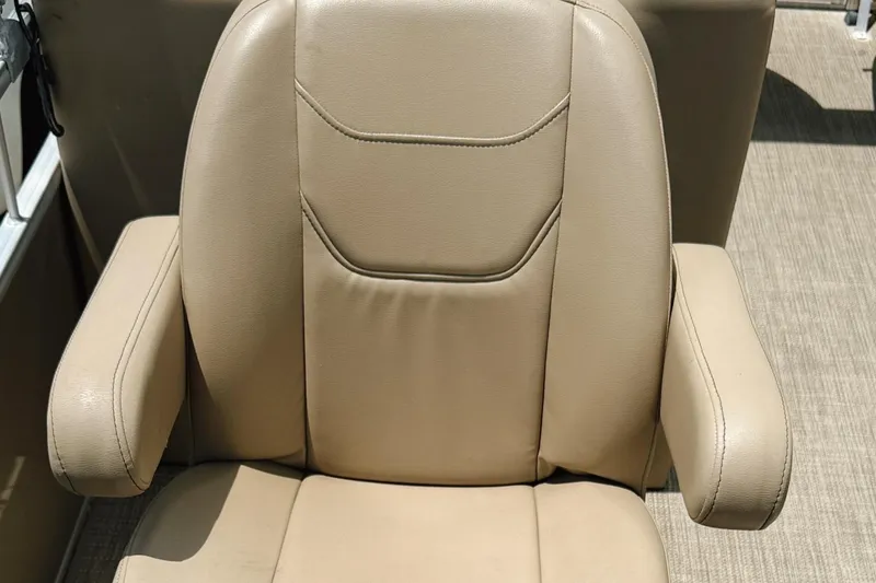 Slide: The Image of Beige leather seat of 2022 Starcraft LX22 boat, featuring armrests and stitching details. - 16