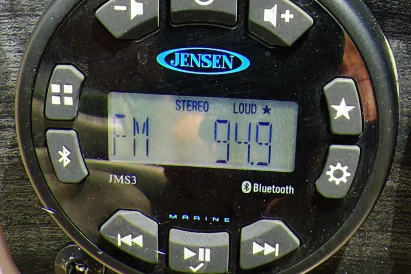 Slide: The Image of Jensen marine stereo display showing FM 94.9, Bluetooth enabled, in a 2022 Starcraft LX22. - 17