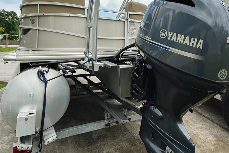 Slide: The Image of 2022 Starcraft LX22 pontoon boat with Yamaha outboard motor on trailer. - 26