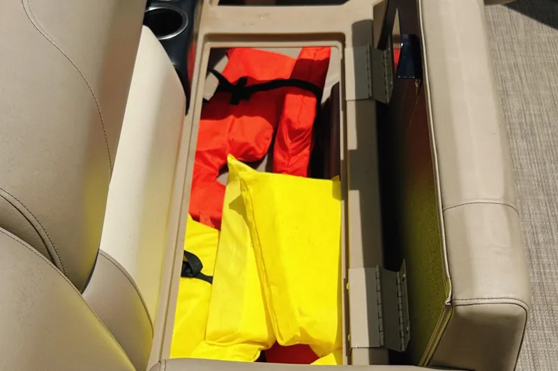 Slide: The Image of Storage compartment in a 2022 Starcraft LX22 boat with life jackets. - 31