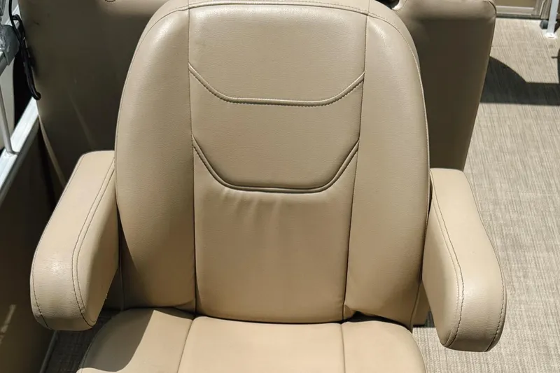 Slide: The Image of Beige leather seat on 2022 Starcraft LX22 boat, featuring armrests and detailed stitching. - 32