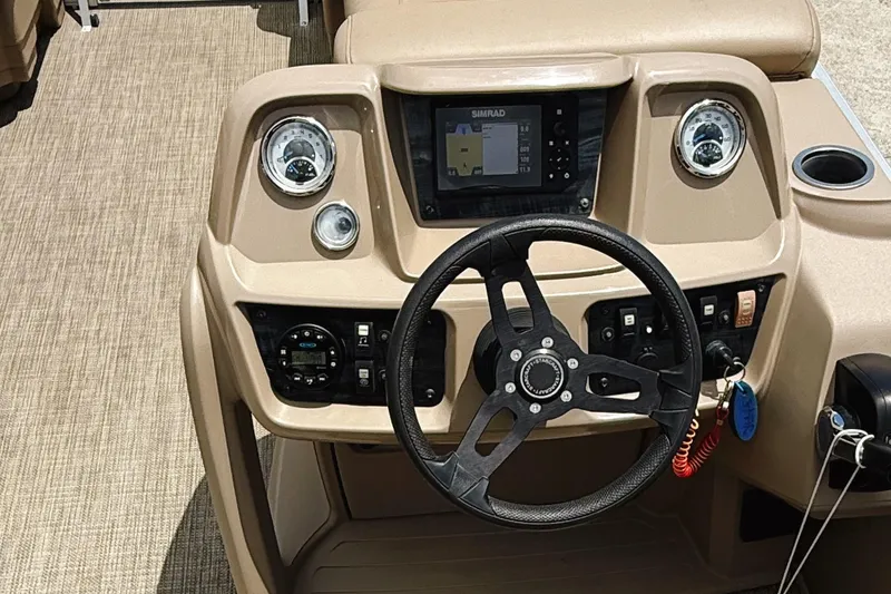 Slide: The Image of 2022 Starcraft LX22 boat dashboard with steering wheel and navigation controls. - 33