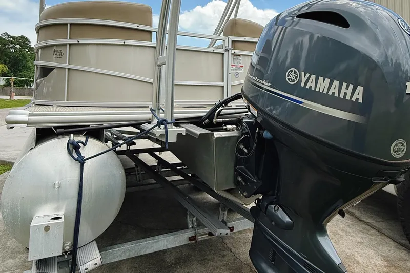 Slide: The Image of 2022 Starcraft LX22 pontoon boat with Yamaha outboard motor on trailer. - 7