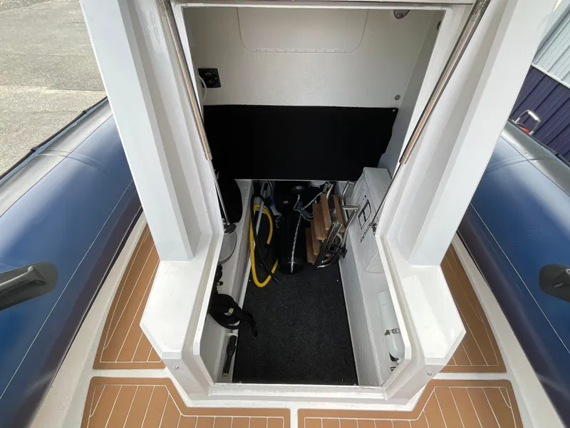 Slide: The Image of Interior view of a 2019 Protector 310 Chase boat, showing storage and equipment. - 10
