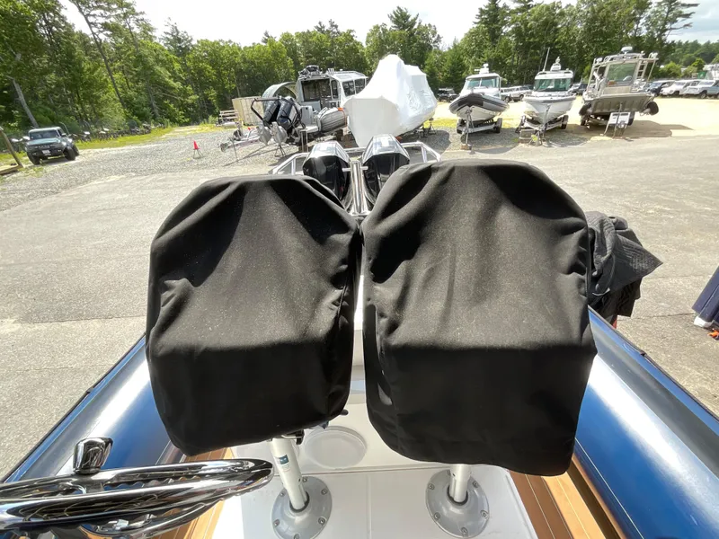 Slide: The Image of 2019 Protector 310 Chase boat with covered seats, parked among other boats. - 11
