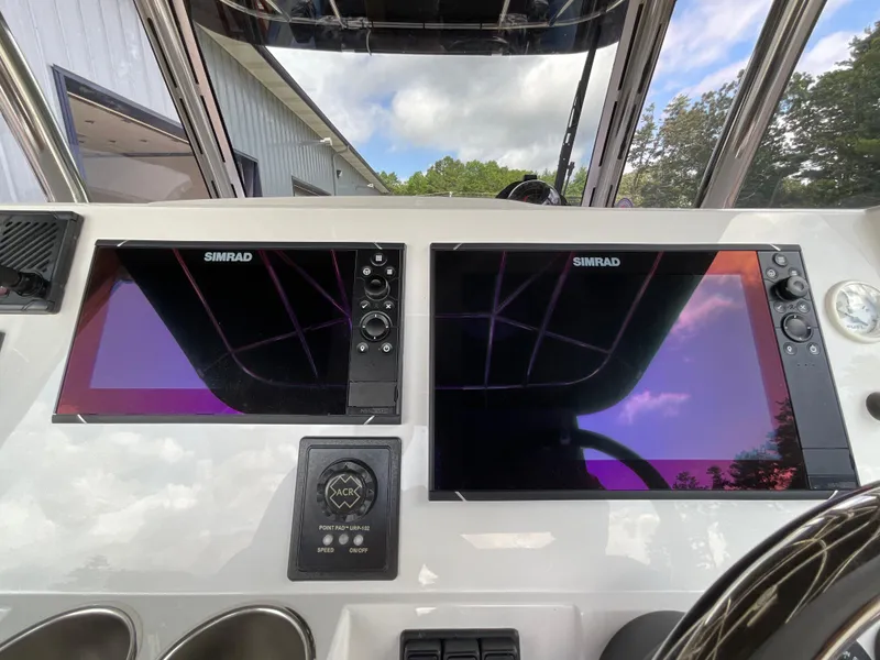 Slide: The Image of Control panel of a 2019 Protector 310 Chase boat with dual Simrad displays. - 14