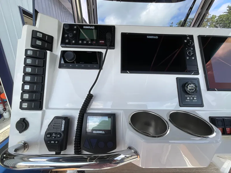 Slide: The Image of Control panel of a 2019 Protector 310 Chase boat with Simrad electronics. - 15