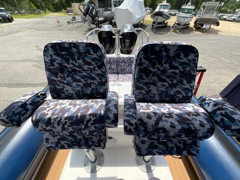 Slide: The Image of Camouflage seats on a 2019 Protector 310 Chase boat, with dual outboard motors. - 16