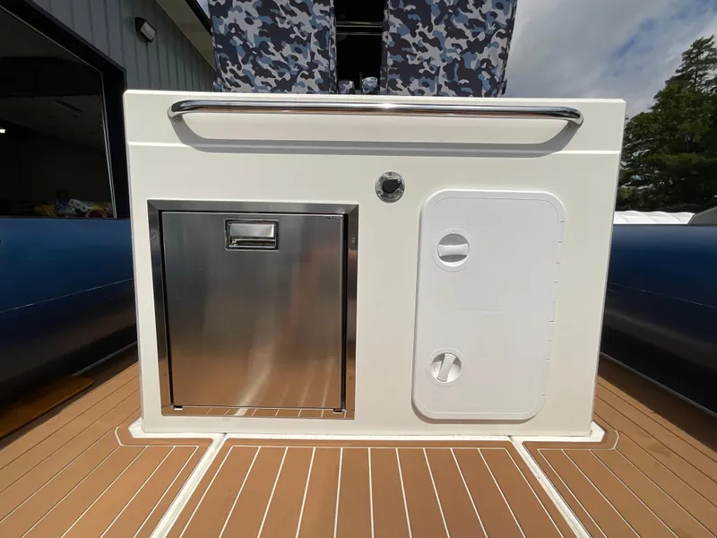 Slide: The Image of 2019 Protector 310 Chase boat interior with stainless steel storage and white panel. - 21