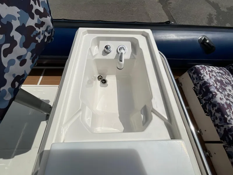 Slide: The Image of 2019 Protector 310 Chase boat sink with faucet and camouflage seating. - 23