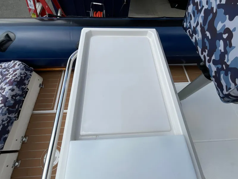 Slide: The Image of 2019 Protector 310 Chase boat interior with camouflage seating and white deck. - 24