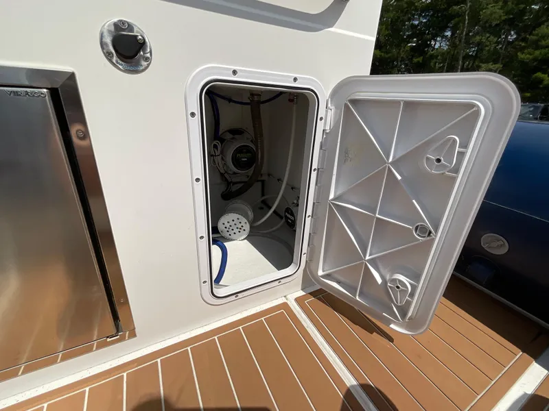 Slide: The Image of Open storage compartment on 2019 Protector 310 Chase boat, showing interior equipment and deck. - 26