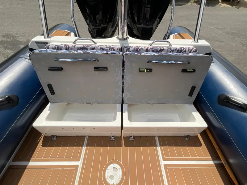 Slide: The Image of 2019 Protector 310 Chase boat with open storage compartments on deck. - 29