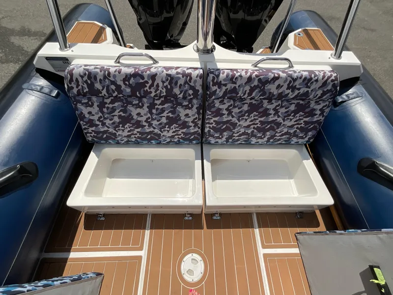 Slide: The Image of 2019 Protector 310 Chase boat interior with camo seats and storage compartments. - 30