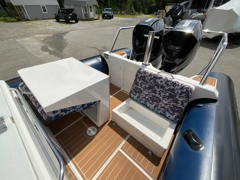 Slide: The Image of 2019 Protector 310 Chase boat interior with camouflage seating and dual outboard motors. - 33