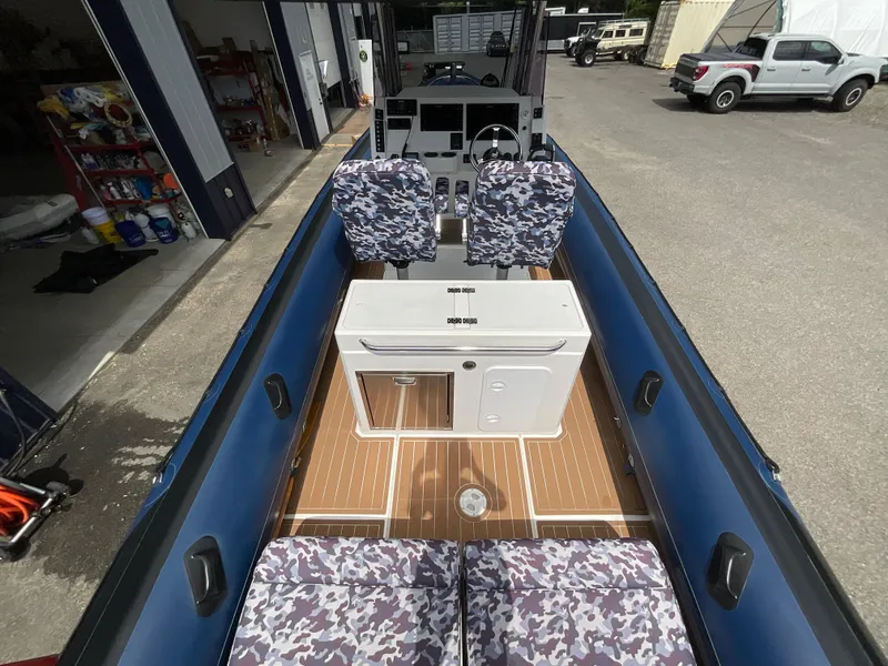 Slide: The Image of 2019 Protector 310 Chase boat interior with camouflage seats and wooden flooring. - 35