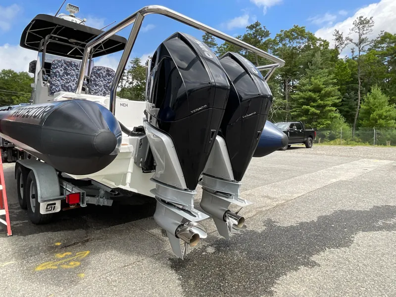 Slide: The Image of 2019 Protector 310 Chase boat with dual outboard motors on a trailer. - 38